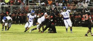 Ladarrius McCrary (45) and Tyler Clark (17) close in to help their teammate take down the Bulldogs’ quarterback, K’hari Lane, in the Panthers’ August 28 match against Macon County in Montezuma.