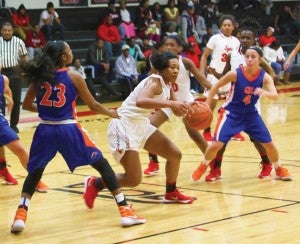 Michael Murray/Americus Times-Recorder:   Mikaela Jones (23) makes her way through a host of Georgia Highlands defenders on her way to the basket during the Lady Jets’ Dec. 10 contest in Americus. 