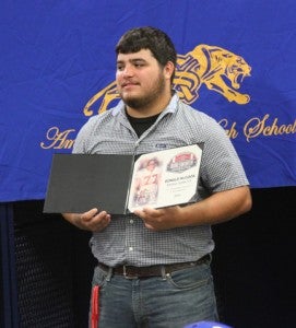 Michael Murray/Americus Times-Recorder: Pictured above, Donald McCook displays the Burlsworth Character Award that he received prior to the signing ceremony for outstanding character and sportsmanship.