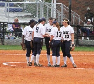 Michael Murray/Americus Times-Recorder:   Members of the Lady ‘Canes converse in the pitchers’ circle during the team’s March 25 contest against Young Harris. Hayley Tierce (22) and Haley Goodson (9) each logged home runs in the Lady ‘Canes’ March 29 double-header against Valdosta State.