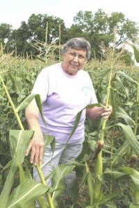 Ellen Chase presents an ear of her family’s famous corn.