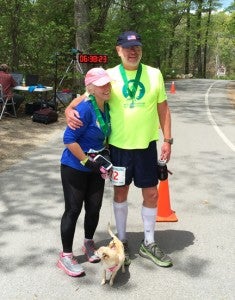 Submitted by Cathy Saylor:   Cathy Saylor pauses for a photo with her husband, Doug, after completing her 79th marathon in New Hampshire, which marked the 50th state in which she has competed.