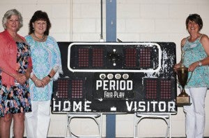 Three players from the 1971 SEAIS class A girls’ state basketball team pose with the championship trophy and original scoreboard from the Smithville Academy gym. From left are Pam McTyeire Oakley, Jackie Fore Wilson and Cathy Cook Williams. The scoreboard was rescued before the academy’s gymnasium was torn down and is in the possession of Charles and Tracy Israel.