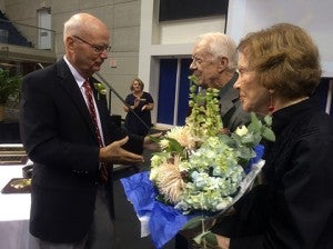 Bill Harris Sr., at left, founder of the Boys & Girls Club of Americus-Sumter County, congratulates President Jimmy and Rosalynn Carter for 18 years of service to the club,