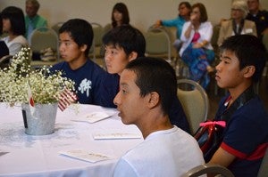 Japanese students listen at the welcoming dinner held at the Rees Park Economic Development Center.