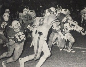 From the 1987 Southland Academy yearbook:   The Raiders’ David Roach bobs and weaves past Westfield defenders during the team’s Nov. 28, 1986 state championship game.