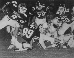 From the 1987 Southland Academy yearbook:   Southland’s David Roach (8) carries the ball around a series of Mt. DeSales defenders as his teammates provide protection during the Raiders’ Nov. 14, 1986 playoff contest against the Cavaliers.