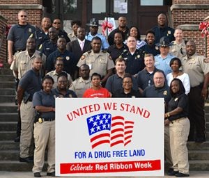 Members of local law enforcement agencies stand united in front of the Sumter County Courthouse to celebrate Red Ribbon Week and a drug-free society.