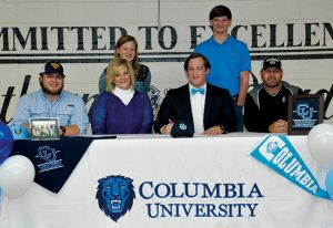 SUBMITTED BY SOUTHLAND ACADEMY: Shown above, in a pfoto from the Feb. 13 edition of the Times-Recorder, Southland defensive end, Taylor Weldon, prepares to sign a national letter of intent to play football at Columbia University as his family members and Raider head coach, Rod Murray (at right) look on.