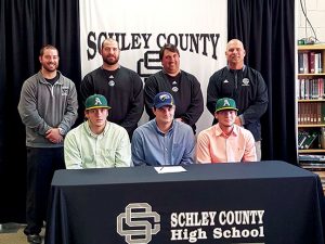 MICHAEL MURRAY I ATR: This photo, from the Feb. 24, 2016 edition of the Times-Recorder, shows Schley County baseball players, (seated, from left) Brett Usry, Michael Leeder, and Blake Howell, moments before signing national letters of intent to continue their baseball careers on the collegiate level in front of members of the Wildcats’ coaching staff.