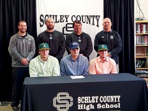 MICHAEL MURRAY I ATR:   This photo, from the Feb. 24, 2016 edition of the Times-Recorder, shows Schley County baseball players, (seated, from left) Brett Usry, Michael Leeder, and Blake Howell, moments before signing national letters of intent to continue their baseball careers on the collegiate level in front of members of the Wildcats’ coaching staff.